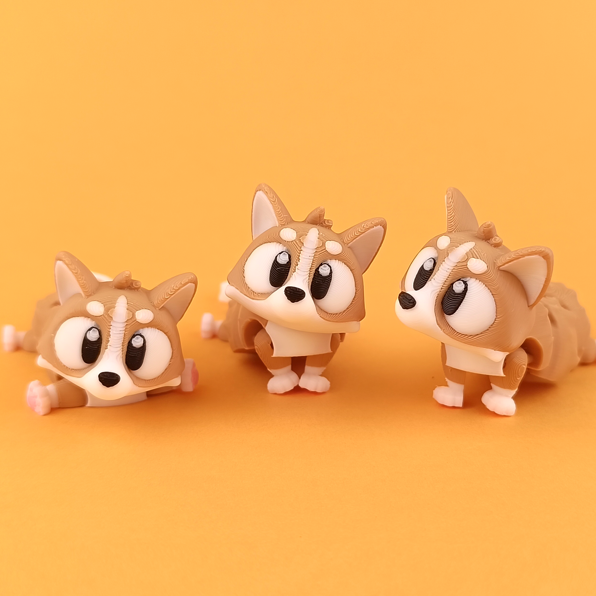 Flexi Corgi Articulated Collectible Trio Orange Background – Wigglix